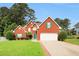 Charming two-story brick home with a well-manicured lawn and attached two-car garage at 3419 Allie Dr, Snellville, GA 30039