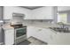 Bright kitchen features white cabinetry, modern appliances, and durable countertops at 3419 Allie Dr, Snellville, GA 30039