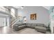 Open-concept living room showcasing a large sectional sofa, high ceilings, and a fireplace at 3419 Allie Dr, Snellville, GA 30039