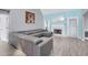 Spacious living room with high ceilings, a modern gray sofa, and a cozy fireplace at 3419 Allie Dr, Snellville, GA 30039