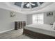 Main bedroom features a tray ceiling, wood flooring, and neutral paint at 3419 Allie Dr, Snellville, GA 30039