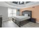 Spacious main bedroom with decorative tray ceiling and wood-look flooring at 3419 Allie Dr, Snellville, GA 30039