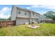 Backyard featuring a patio set, fire pit, and a large grassy area with a swing set at 588 Joneus Dr, Mcdonough, GA 30252