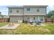 Backyard featuring a patio set, fire pit, and a large grassy area at 588 Joneus Dr, Mcdonough, GA 30252