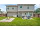 Backyard featuring a patio set, fire pit, and a large grassy area at 588 Joneus Dr, Mcdonough, GA 30252