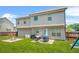 Backyard featuring a patio set, fire pit, and a large grassy area at 588 Joneus Dr, Mcdonough, GA 30252