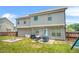 Backyard featuring a patio set, fire pit, and a large grassy area at 588 Joneus Dr, Mcdonough, GA 30252