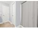 Neutral bathroom with a shower featuring a grey curtain and white doors at 588 Joneus Dr, Mcdonough, GA 30252