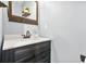 Bathroom featuring a wood vanity with quartz countertop, decorative mirror, and neutral paint at 588 Joneus Dr, Mcdonough, GA 30252