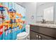 Cute bathroom with 'Paw Patrol' shower curtain, granite vanity, and toilet at 588 Joneus Dr, Mcdonough, GA 30252