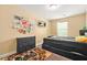 Bedroom features a black platform bed, carpet, and window at 588 Joneus Dr, Mcdonough, GA 30252