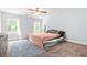 Bedroom with a ceiling fan, carpet, large bed, and neutral paint at 588 Joneus Dr, Mcdonough, GA 30252