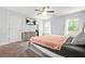 Main bedroom with a ceiling fan, neutral paint, carpet, a large bed, and natural light at 588 Joneus Dr, Mcdonough, GA 30252