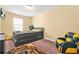 Inviting bedroom with a modern bed, gaming chair, and soft carpeting at 588 Joneus Dr, Mcdonough, GA 30252