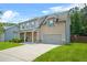Two-story home with attached garage, stone accents, well maintained lawn, and mature landscaping at 588 Joneus Dr, Mcdonough, GA 30252