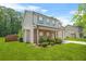 Two-story home with stone accents, covered porch, well maintained lawn, and mature landscaping at 588 Joneus Dr, Mcdonough, GA 30252