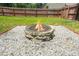 Outdoor fire pit with stone surround in a spacious and well-maintained backyard at 588 Joneus Dr, Mcdonough, GA 30252