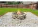 Outdoor fire pit with stone surround in a spacious and well-maintained backyard at 588 Joneus Dr, Mcdonough, GA 30252