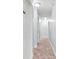 A bright hallway with neutral walls, carpet, doors, and lighting at 588 Joneus Dr, Mcdonough, GA 30252