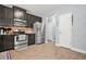 Modern kitchen features stainless steel appliances, dark cabinets, and an efficient layout at 588 Joneus Dr, Mcdonough, GA 30252