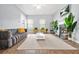 Open-concept living room with modern furniture, large windows, fireplace and view of dining area at 588 Joneus Dr, Mcdonough, GA 30252