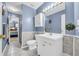 Bathroom featuring a vanity with cabinets, sink, toilet, and a decorative mirror with lighting at 6178 Field Stone Dr, Douglasville, GA 30134
