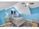 Bright bedroom with blue walls, ceiling fan, an arched window and light-colored wooden floors at 6178 Field Stone Dr, Douglasville, GA 30134