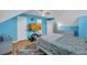 A bedroom with light hardwood floors, a mounted TV, and blue colored walls at 6178 Field Stone Dr, Douglasville, GA 30134