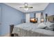 Comfortable bedroom with blue walls, ceiling fan, and a TV set on top of a dresser at 6178 Field Stone Dr, Douglasville, GA 30134