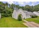 Exterior view of a charming home with a well-manicured lawn surrounded by lush greenery and mature trees at 6178 Field Stone Dr, Douglasville, GA 30134