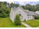 Exterior view of a charming home with a well-manicured lawn surrounded by lush greenery and mature trees at 6178 Field Stone Dr, Douglasville, GA 30134