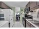 Open kitchen with stainless appliances, tile floor, and a view into the dining and living areas at 6178 Field Stone Dr, Douglasville, GA 30134
