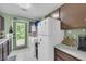 A well-lit laundry area featuring appliances, ample counter space, and a door to the exterior at 6178 Field Stone Dr, Douglasville, GA 30134