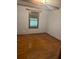 Cozy bedroom featuring wood floors, a wooden window, and light blue walls at 718 South Ave, Forest Park, GA 30297