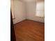 Cozy bedroom with hardwood floors, neutral paint and natural light from two windows at 718 South Ave, Forest Park, GA 30297
