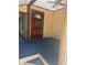 Traditional home entryway with a dark wood door, textured walls, and blue carpeting at 718 South Ave, Forest Park, GA 30297
