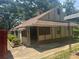 Exterior view of the home with a covered entry and light-colored siding at 718 South Ave, Forest Park, GA 30297