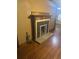 A fireplace with a tile border, situated in a room with hardwood floors at 718 South Ave, Forest Park, GA 30297