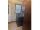 Laundry room featuring a vintage washing machine, and wood cabinets at 718 South Ave, Forest Park, GA 30297