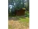 Backyard view of a backyard shed, with trees in the background at 718 South Ave, Forest Park, GA 30297