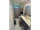 Well-lit bathroom featuring a large vanity and shower-tub combo at 751 Stonecreek Way, Stone Mountain, GA 30087