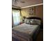 Comfortable bedroom featuring a queen-size bed, elegant linens, a window for natural light, and tasteful decor at 751 Stonecreek Way, Stone Mountain, GA 30087
