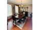 Formal dining room featuring hardwood floors, stylish decor, and a chandelier over a large dining table at 751 Stonecreek Way, Stone Mountain, GA 30087