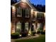 Charming brick home exterior, accentuated by stylish dark shutters and decorative outdoor lighting at 751 Stonecreek Way, Stone Mountain, GA 30087