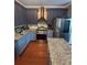 Well-appointed kitchen with stainless steel appliances, granite counters, and elegant backsplash detail at 751 Stonecreek Way, Stone Mountain, GA 30087