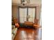 Cozy living room featuring large windows, hardwood floors, stylish curtains, and comfortable seating at 751 Stonecreek Way, Stone Mountain, GA 30087