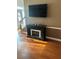 Cozy living room showcasing a fireplace and mounted TV at 751 Stonecreek Way, Stone Mountain, GA 30087