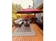 Inviting outdoor seating area under a red umbrella, perfect for enjoying the weather at 751 Stonecreek Way, Stone Mountain, GA 30087