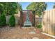 Cozy backyard sitting area with wood feature, bench, and privacy fence at 830 Club Chase Ct, Roswell, GA 30076