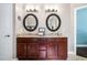 This bathroom features and sinks with dark wood cabinets and granite countertops at 830 Club Chase Ct, Roswell, GA 30076